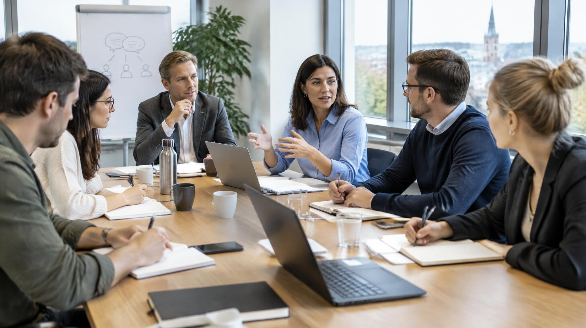 Adults taking notes during a business communication discussion