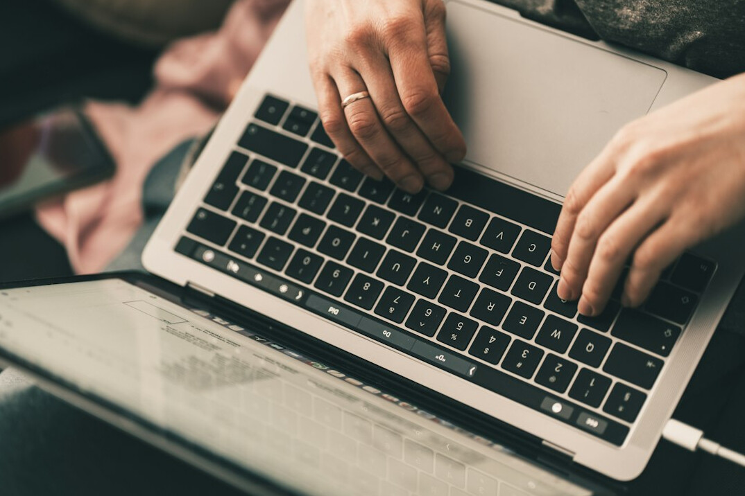 professional writing on laptop