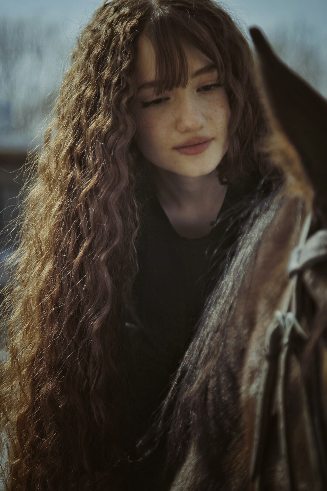 Portrait of a young woman with long hair smiling