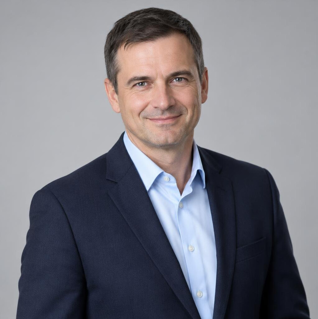 Portrait of a man in a suit with a confident smile
